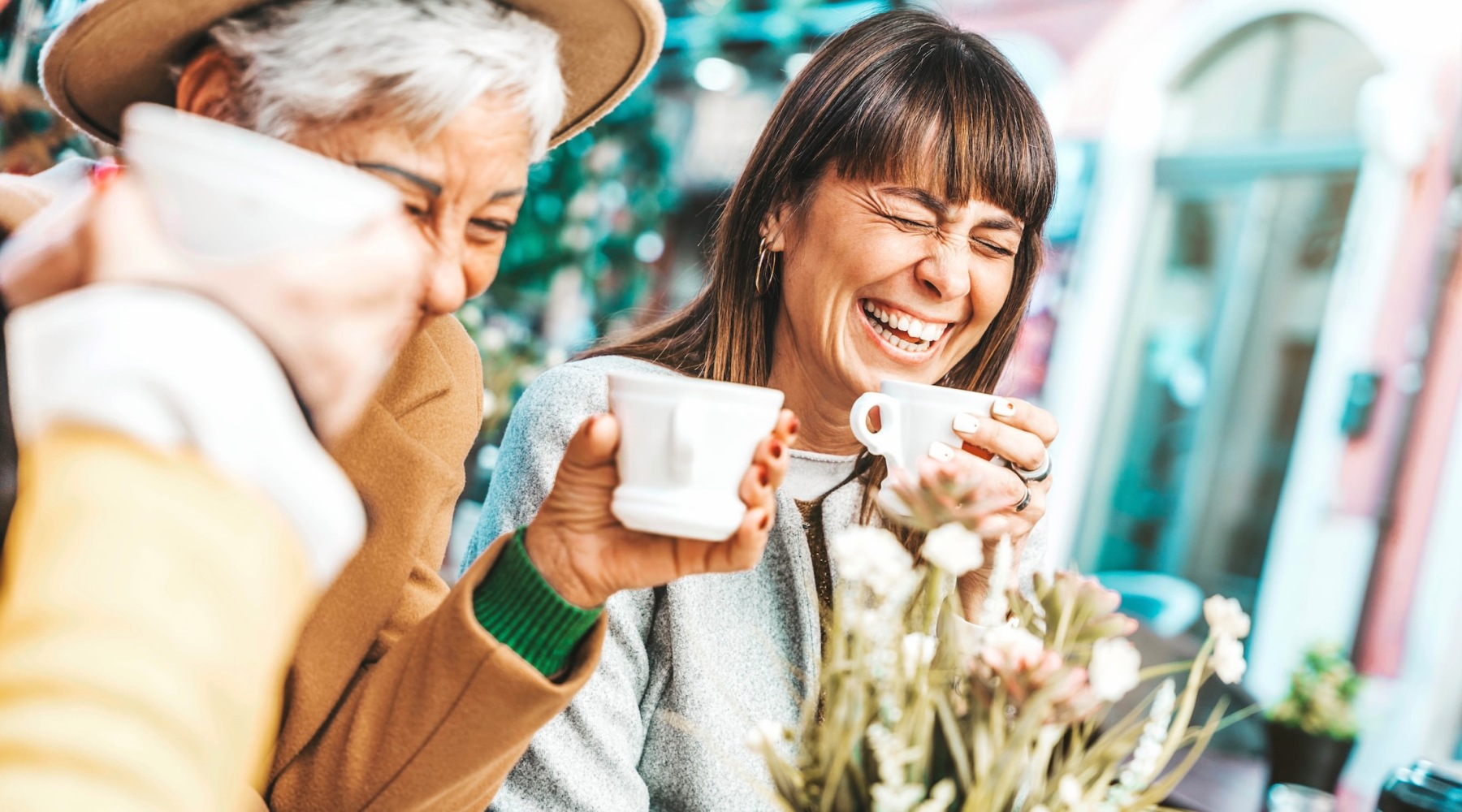a family and friends laughing and drinking coffee
